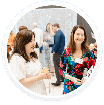 Two women at a youth volunteer event in Texas discuss family volunteering programs.