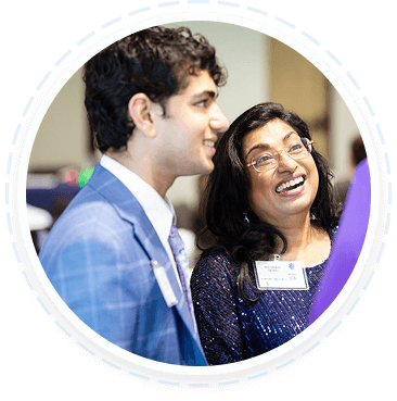 Two teens in business attire discuss youth volunteer programs in Texas at an event.