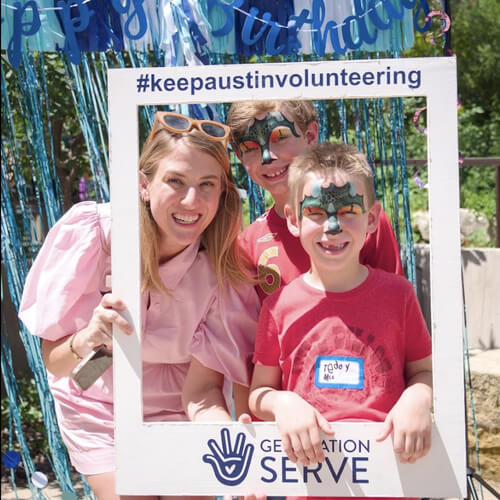 A family with face paint smiles at a youth volunteer event in Texas for teen and family volunteering.