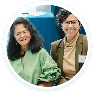 Two women smile, representing youth and family volunteering programs in Texas.