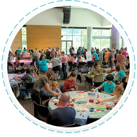 Teens and families volunteer in Texas youth programs, making crafts together.