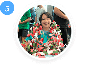 A teen volunteer smiles with paper chains during a youth service event in Texas.