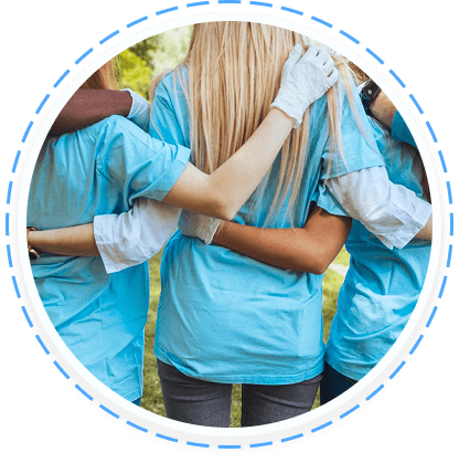 Three youth volunteers in blue shirts embrace, symbolizing teen service programs Texas.