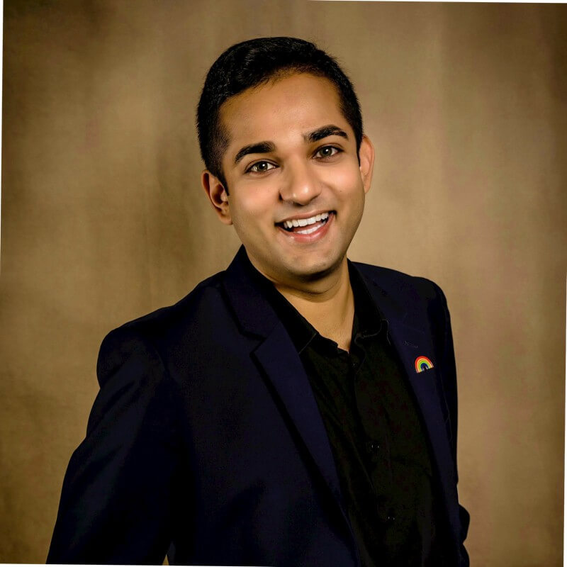 A youth volunteer smiles in a blazer, representing teen service programs in Texas.
