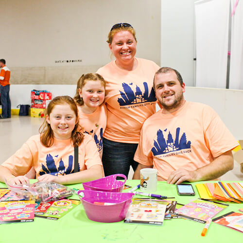 A smiling family joins Family Volunteer Day, exploring youth volunteer programs Texas.