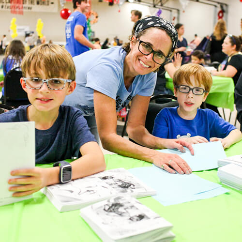 A woman and two boys join a youth volunteer program in Texas for Family Volunteer Day.