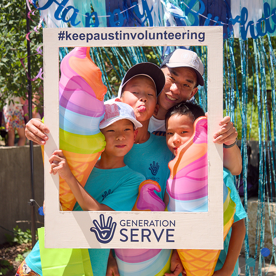 A man and three kids pose with ice creams at a youth volunteer event in Texas.