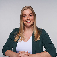Board Member Kimberley Wenger, leader in youth volunteer programs Texas, smiles at table.