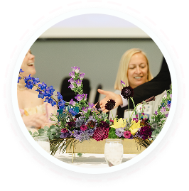 Teens at a table discuss youth volunteer programs in Texas as an auction begins.