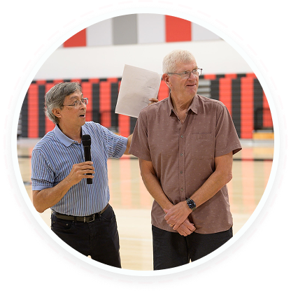 Two men at a youth volunteer program in Texas discuss teen service and family volunteering.