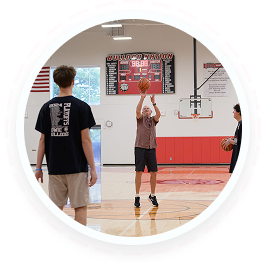 Teens in a youth volunteer program help seniors play basketball during a family volunteering event in Texas.
