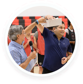 Two men at a youth volunteer event in Texas, with family volunteering and teen service programs.