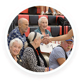 Teens in youth volunteer programs Texas greet seniors at a family volunteering event.